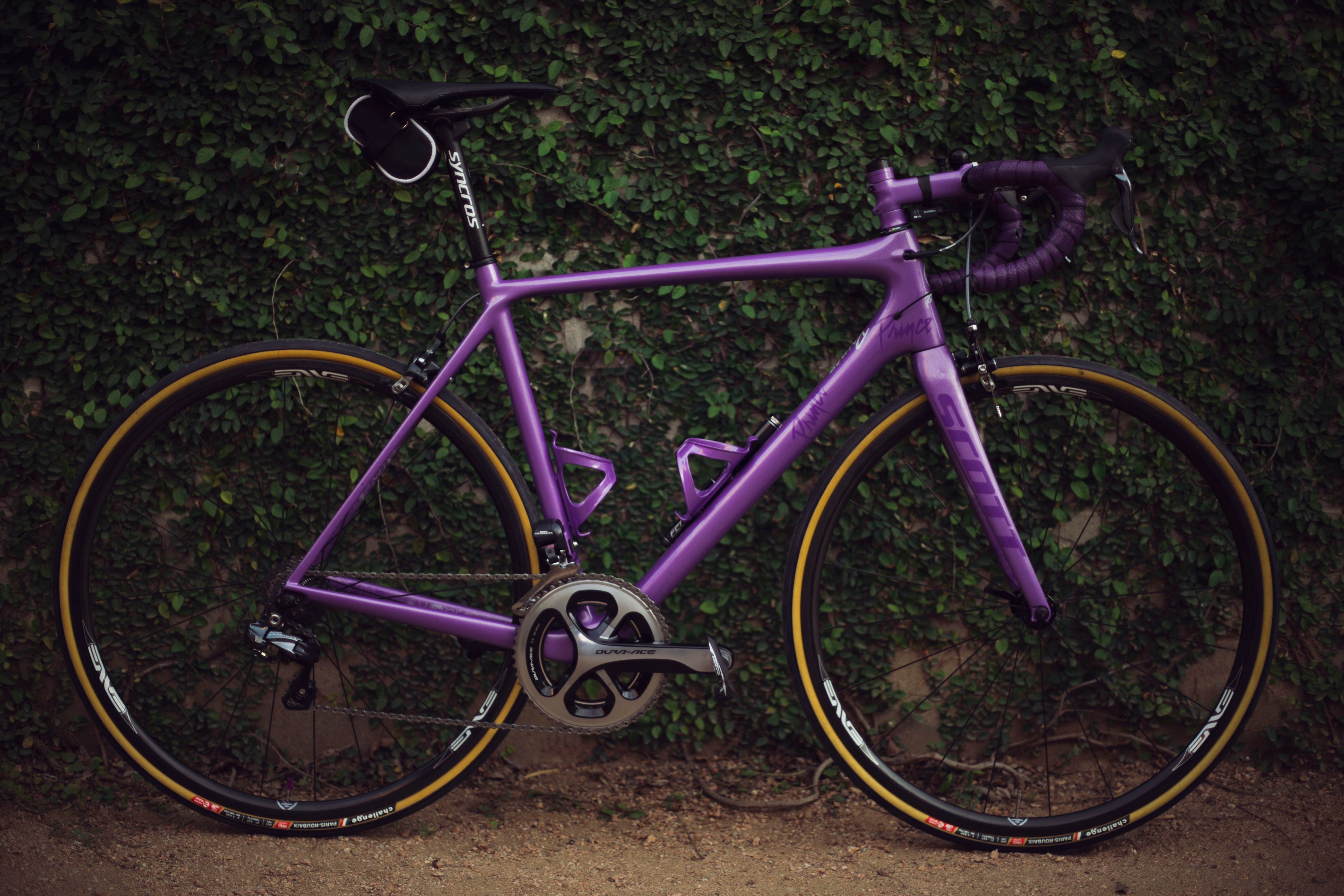 purple road bike near wall
